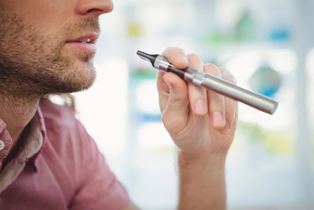 image of man smoking vaporizer