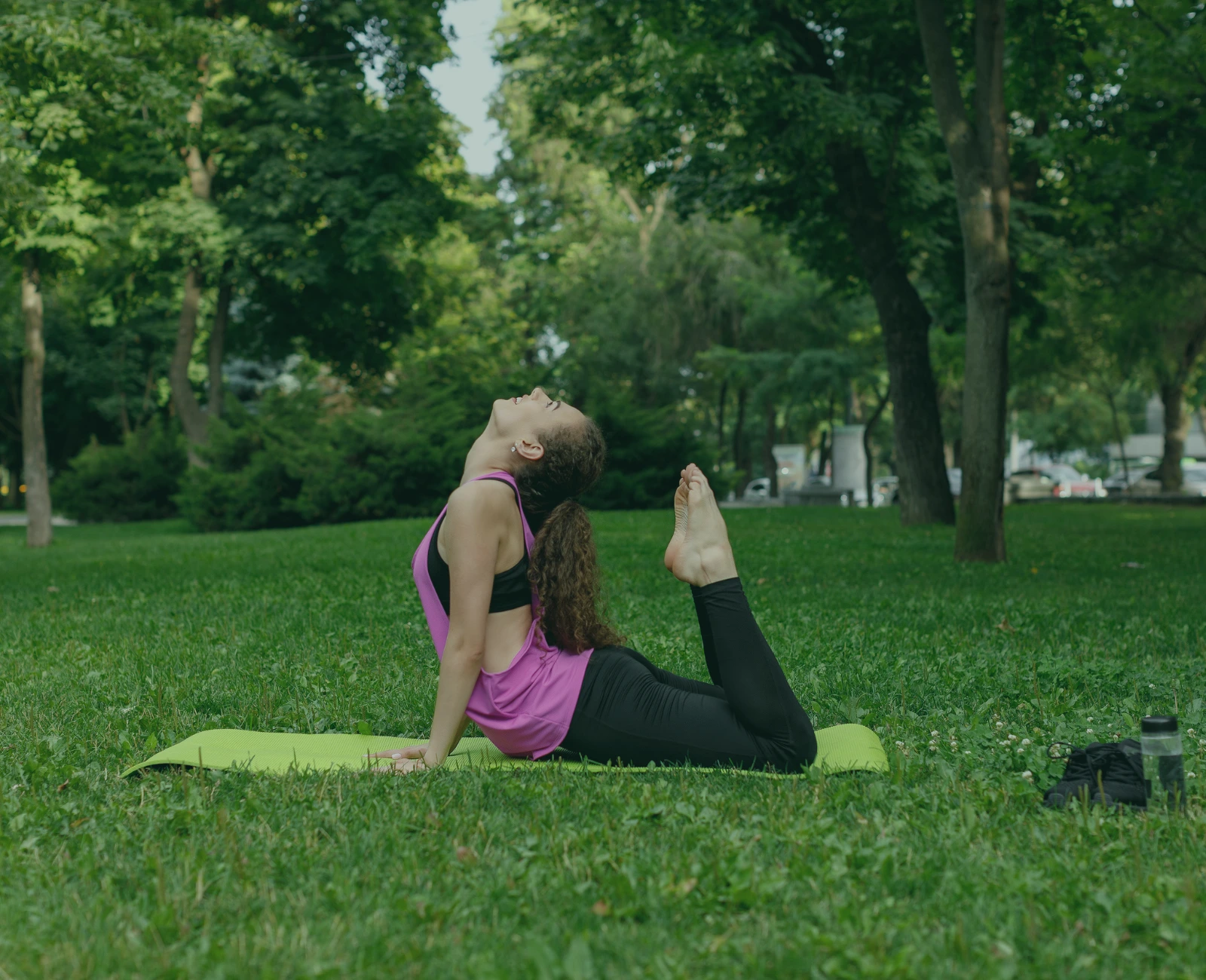 Woman doing yoga in park after taking best outdoor weed strains